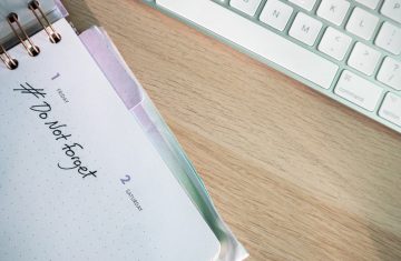 A close-up shot of a planner and keyboard on a desk, showcasing organization.